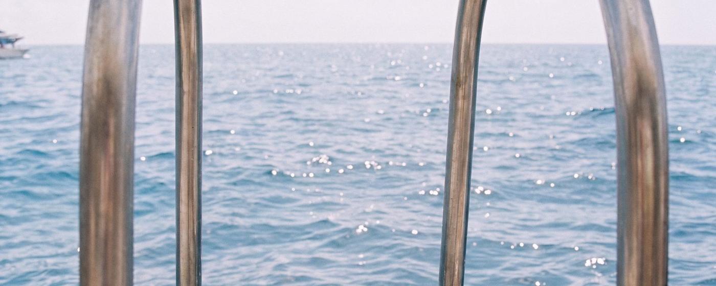Empty location: chrome ladder rails over the sea